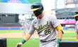 Oakland A's Tyler Nevin #26 is being congratulated after scoring during the sixth inning o...