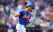 Mark Vientos #27 of the New York Mets is gesturing towards the dugout after homering durin...
