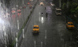 A yellow ambassador taxi is moving slowly following heavy monsoon rains in Kolkata, West B...