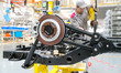A worker is welding a new energy vehicle at the production workshop of the Qingdao headqua...