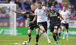 Eoin Toal #18 of Bolton Wanderers F.C. is being tackled by the opponent during the Sky Bet...