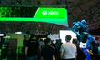Gaming enthusiasts play at the Xbox booth during the opening day of Gamescom in Cologne, G...