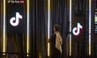 A visitor walks past a TikTok gaming booth during the opening day of Gamescom in Cologne,...