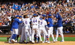 New York Mets' Jesse Winker #3 is mobbed by teammates after hitting a game-winning solo ho...