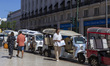 A driver waits in a Tuk Tuk car for tourists in Lisbon, Portugal, on August 24, 2024. Tour...