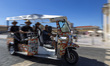 A Tuk Tuk transports tourists in Lisbon, Portugal, on August 24, 2024. Tourism in Portugal...