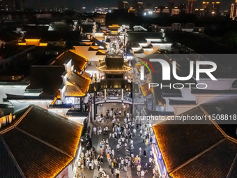A large number of tourists watch a light show at the ancient Drum Tower in Ningbo, Zhejiang province, China, on the evening of August 24, 20... by Costfoto/NurPhoto