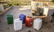 Plastic cans filled with water at a drinking water point in the isolated rural area of Chr...
