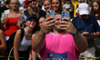 CHORZOW, POLAND - AUGUST 25:Joe Kovacs of the USA takes selfies with fans after competing...