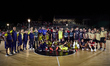 Players of both teams pose for a family photo after the pre-season friendly match between...