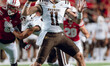 Western Michigan quarterback Hayden Wolff #11 drops back to pass against the Wisconsin Bad...