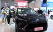 People look at various vehicles at the 23rd Autumn International Auto Show in Qingdao, Chi...