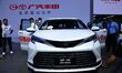 People look at various vehicles at the 23rd Autumn International Auto Show in Qingdao, Chi...