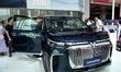 People look at various vehicles at the 23rd Autumn International Auto Show in Qingdao, Chi...
