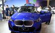 People look at various vehicles at the 23rd Autumn International Auto Show in Qingdao, Chi...