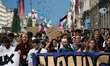 People march holding a banner that reads, 'A single solution destitution', during a protes...