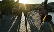 Tourists walk on Charles Bridge as the sun sets in Prague, Czech Republic, on September 10...