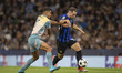 Carlos Augusto #30 of Inter Milan is tackled by Rodri #16 of Manchester City F.C. during t...