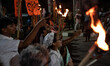People hold a procession with torches to protest the recent violent clashes and counter-cl...