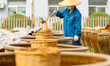 A worker suns soy sauce in Tengzhou, China, on September 21, 2024. 