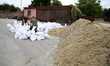 Soldiers from the 1st Brzeg Sapper Regiment prepare sandbags during flooding due to the Od...