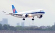 The first C919 passenger plane of China Southern Airlines prepares to land on the runway a...