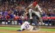 Mark Vientos #27 of the New York Mets scores as Philadelphia Phillies catcher J.T. Realmut...