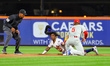 New York Mets' Luisangel Acuna #2 is tagged out by Philadelphia Phillies' 2B Bryson Stott...