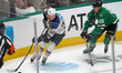 Zach Dean #52 of the St. Louis Blues skates with control of the puck while defended by Tho...