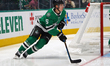 Nils Lundkvist #5 of the Dallas Stars skates up the ice while controlling the puck during...