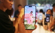 Customers experience Apple's new flagship mobile phone, the iPhone 16, at the largest Appl...