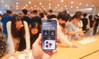 Customers experience Apple's new flagship mobile phone, the iPhone 16, at the largest Appl...