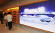 Customers experience Apple's new flagship mobile phone, the iPhone 16, at the largest Appl...