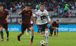 Nicolas Diaz #4 of Xolos de Tijuana and Rogelio Funes Mori #29 of Pumas de la UNAM fight f...