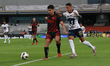 Diego Barbosa #15 of Xolos de Tijuana and Robert Ergas #22 of Pumas de la UNAM fight for t...