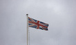 The Union Jack or Union Flag on a flagpole on top of the British Museum with clouds. Gener...