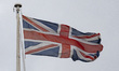The Union Jack or Union Flag on a flagpole on top of the British Museum with clouds. Gener...