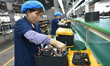 Workers work at a mobile energy storage power production workshop of an electric company i...
