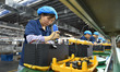 Workers work at a mobile energy storage power production workshop of an electric company i...