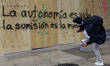 Members of the anarchist Black Bloc carry out direct action while accompanying the mothers...