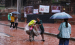 A vendor pushes his load-laden bicycle through Patan Durbar Square, a UNESCO World Heritag...