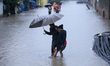 A Nepali woman wades through the floodwater in Kathmandu, Nepal, on September 27, 2024. Th...