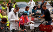 Volunteers prepare food for aid workers and affected citizens as massive flooding affected...