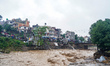 The flooding of the Nakhu River damages the road and riverbank during heavy rainfall in La...
