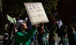 A woman shouts while holding a placard reading 'Abortion, my body, my choice'. For Interna...