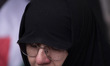 A veiled Iranian woman mourns while taking part in a protest gathering to condemn an Israe...