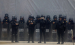 Policewomen guard women marching in Mexico City, Mexico, on September 28, 2024, from the G...