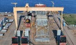 A hull section that will be sent to the final assembly base is loaded onto a semi-submersi...
