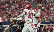 Arkansas Razorbacks quarterback Taylen Green #10 rolls out of the pocket and throws the ba...