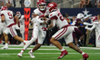 Arkansas Razorbacks quarterback Taylen Green #10 hands off to Arkansas Razorbacks running...